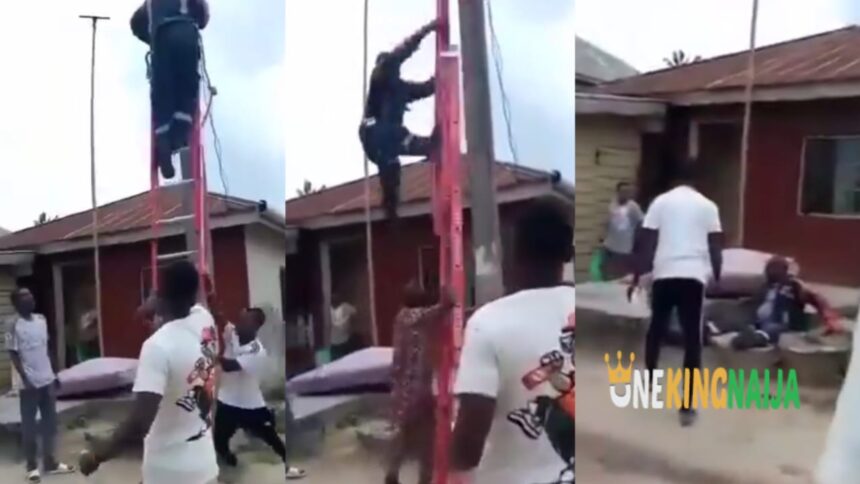 NEPA officer who went to disconnect light at an undisclosed area was pushed off the ladder by angry Nigerians. Clips trends (VIDEO)